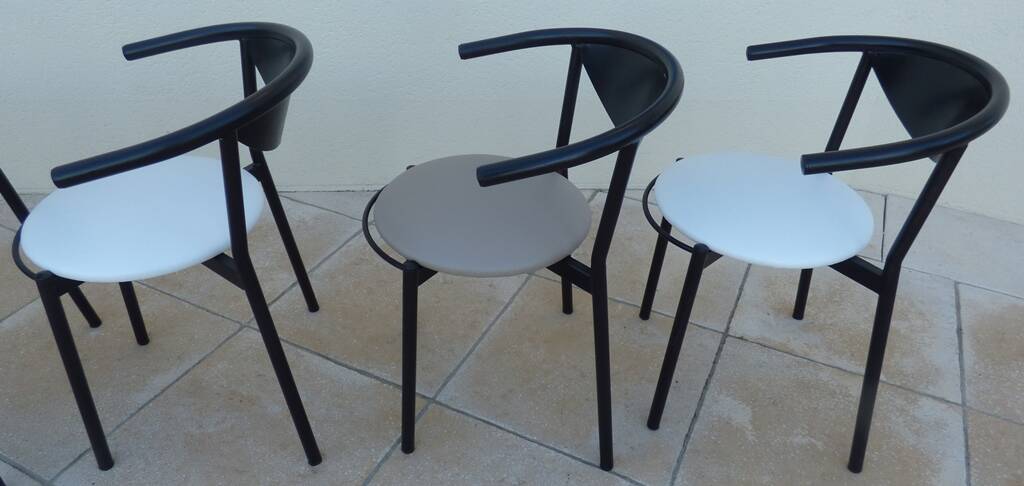 6 gondola-style chairs with a sturdy metal frame and faux leather.