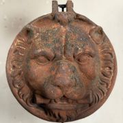 Three cast-iron and terracotta façade decoration lions, around 1880.