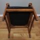 Fauteuil colonial en teck et cuir noir