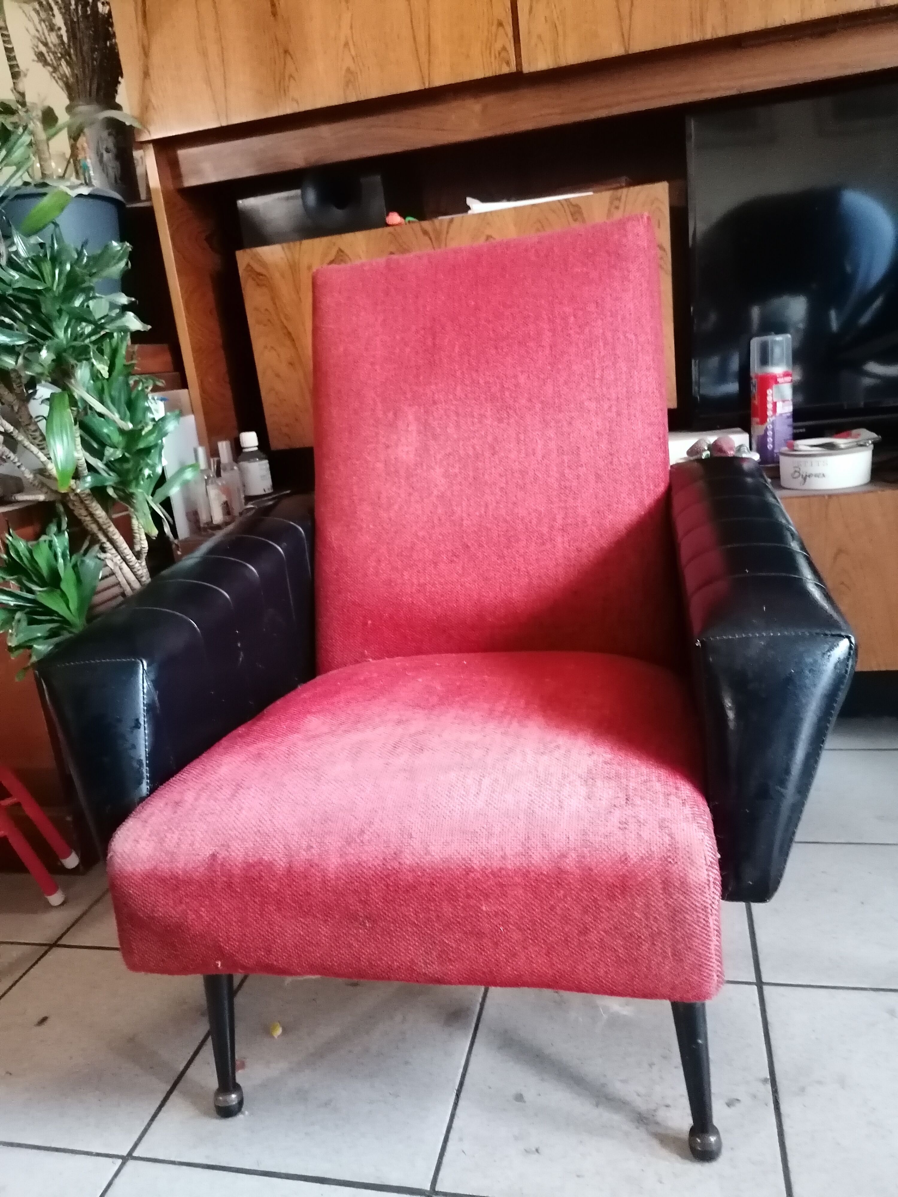 Red and black chair with brass feet
