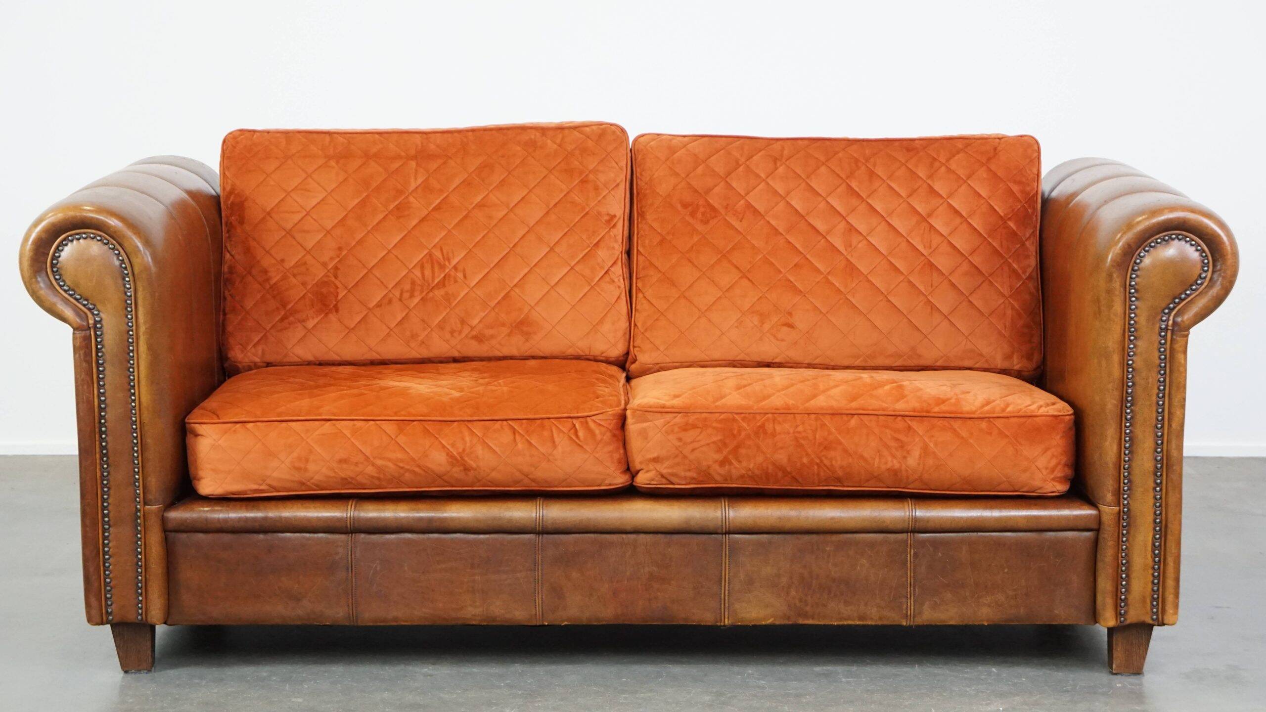 Luxury and comfortable sheepskin 2.5-seater sofa of top quality with orange fabric seat and back cushions
