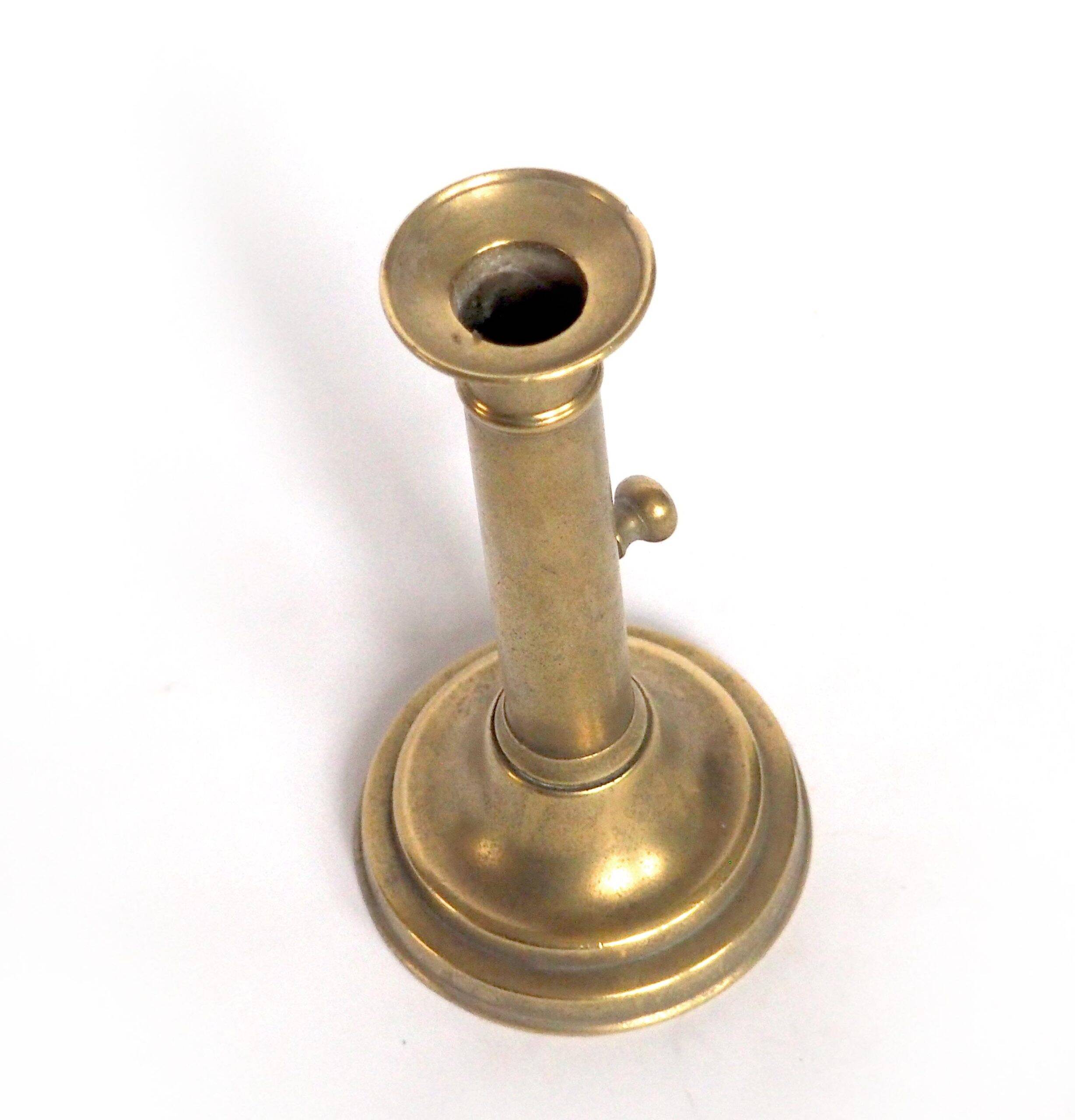Brass candlestick with a column and bobeche.