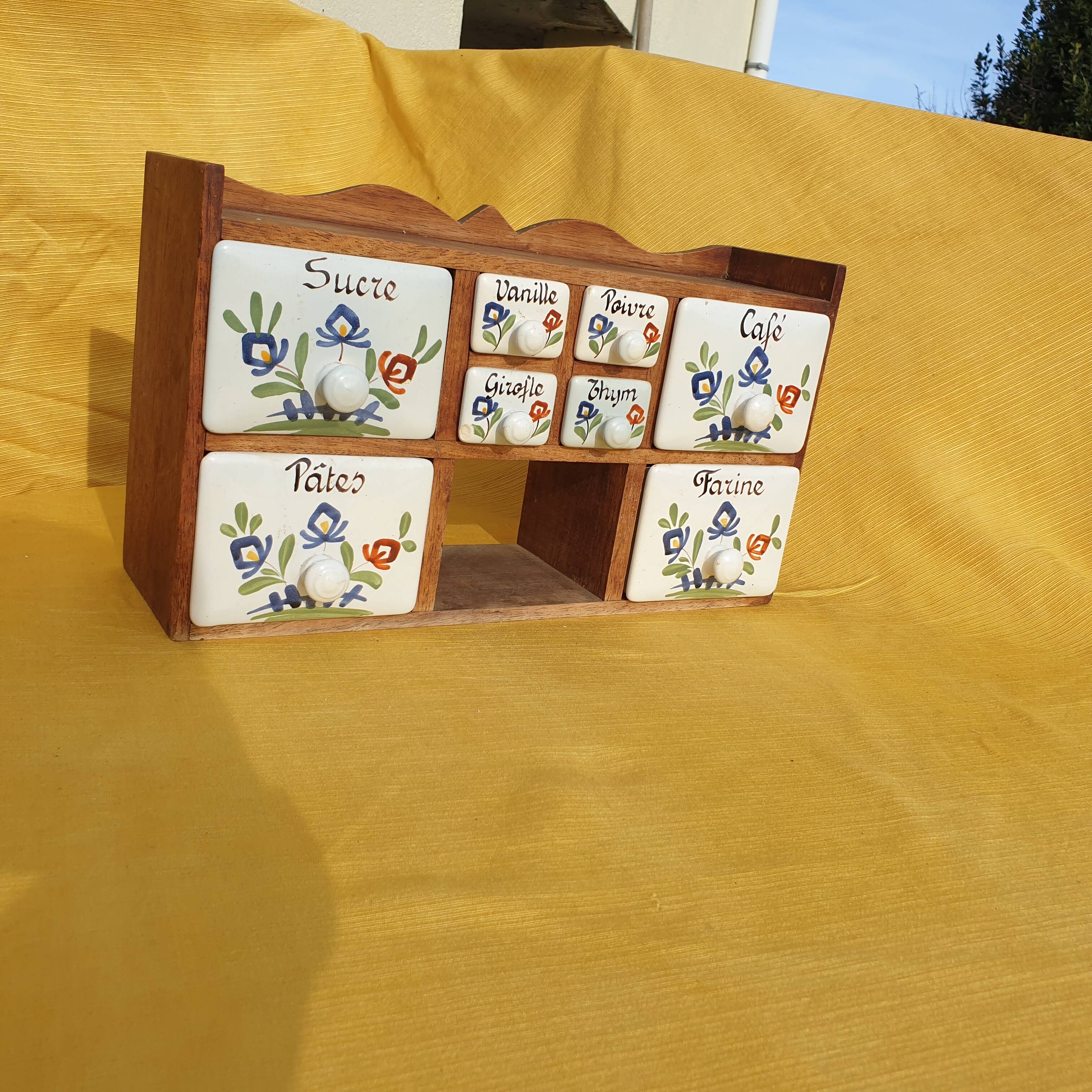 Vintage wooden spice rack with ceramic drawers