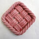 Woven pair of bottle coasters, in pink Vallauris earthenware.