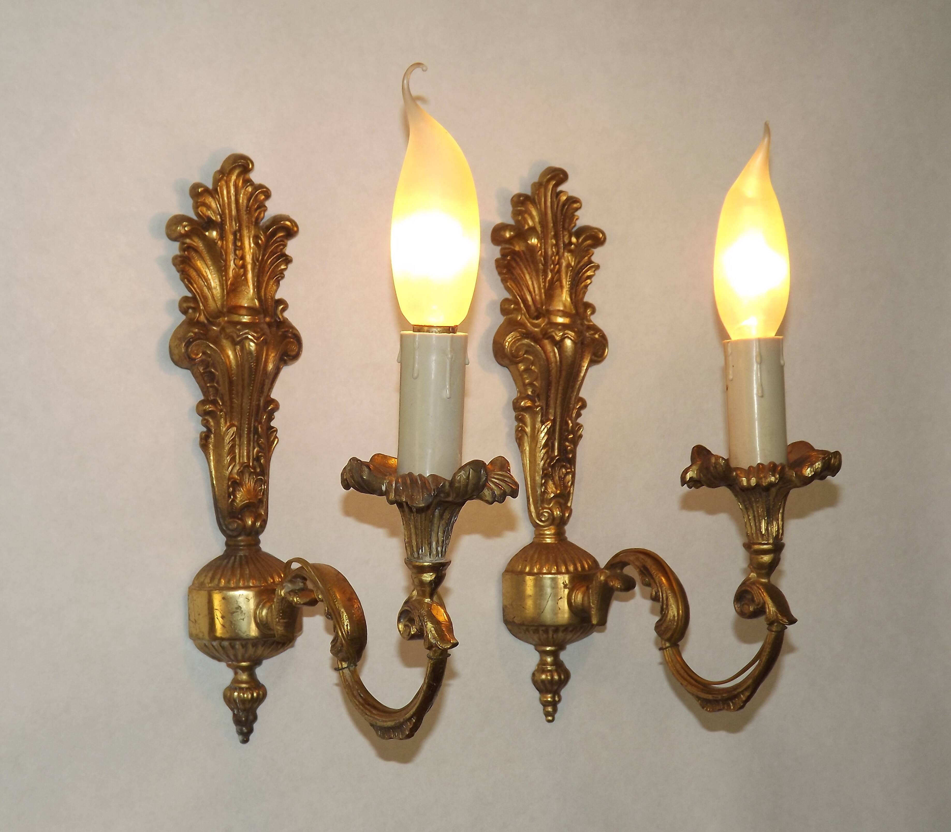Pair of simple vintage French wall sconces in Art Nouveau bronze with leaf-shaped details.