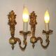 Pair of simple vintage French wall sconces in Art Nouveau bronze with leaf-shaped details.