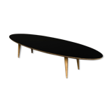 Oval coffee table with a black tray and oak-turned feet