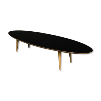 Oval coffee table with a black tray and oak-turned feet
