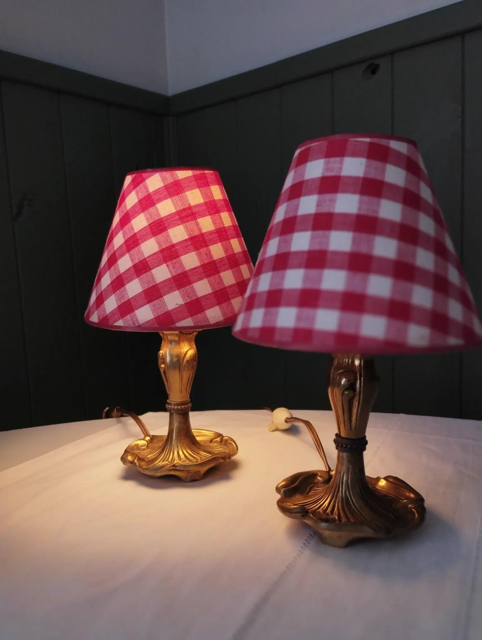 Pair of small lamps in gilded bronze by Petitot and red gingham lampshades.