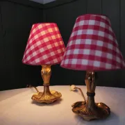 Pair of small lamps in gilded bronze by Petitot and red gingham lampshades.