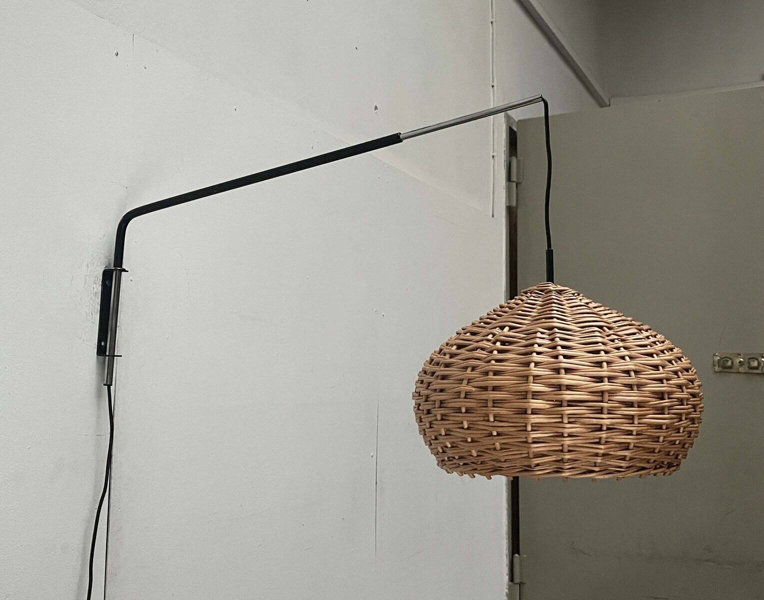 Mid-century modern Danish extendable cantilever wall lamp with a rattan shade, 1960s.