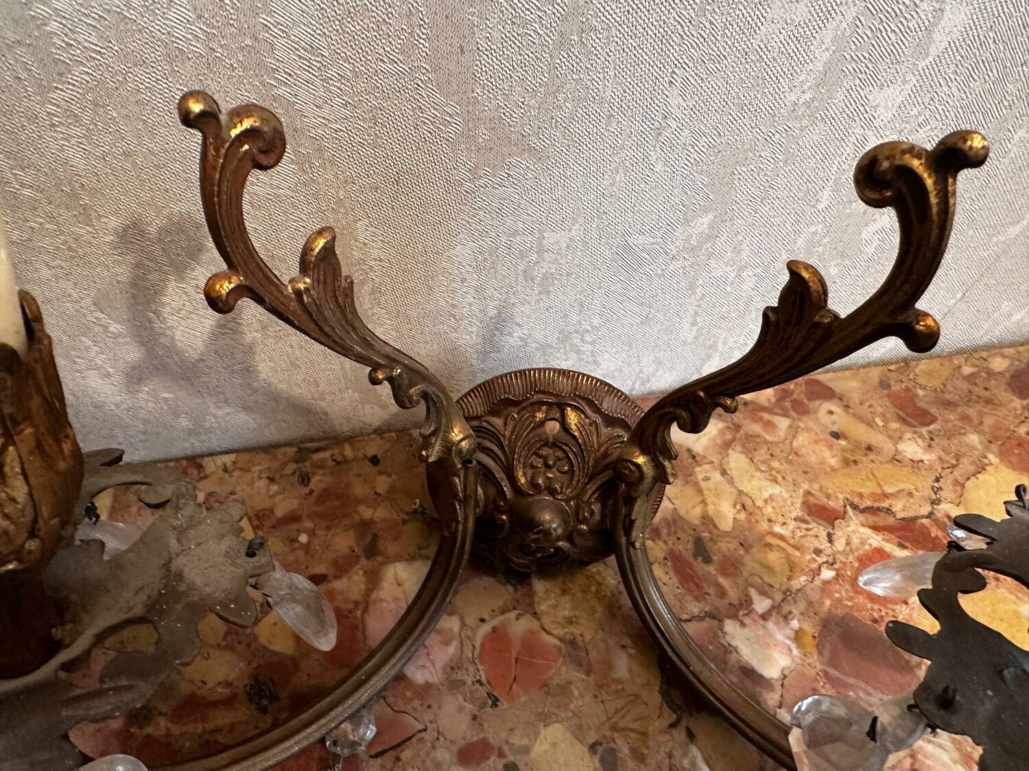 Pair of Louis XV style wall sconces in gilded bronze with glass pendants.