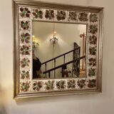 Large square ceramic mirror with floral decoration.