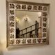 Large square ceramic mirror with floral decoration.