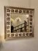 Large square ceramic mirror with floral decoration.