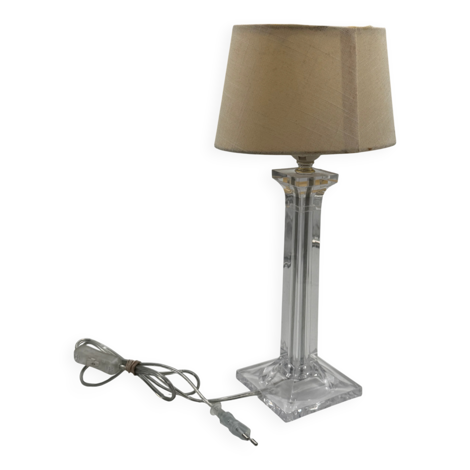 Modern table lamp in plexiglass with fabric shade.