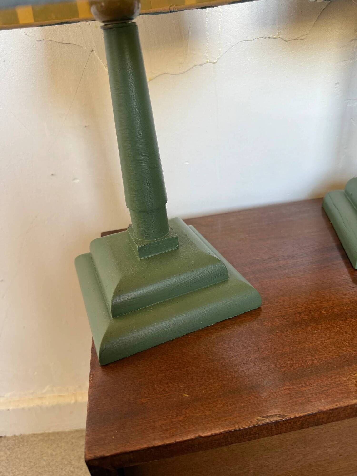 Pair of vintage wooden lamps with their striped beige, blue, and green shades.