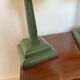 Pair of vintage wooden lamps with their striped beige, blue, and green shades.