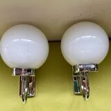 Pair of chrome metal wall lights with white glass globe.
