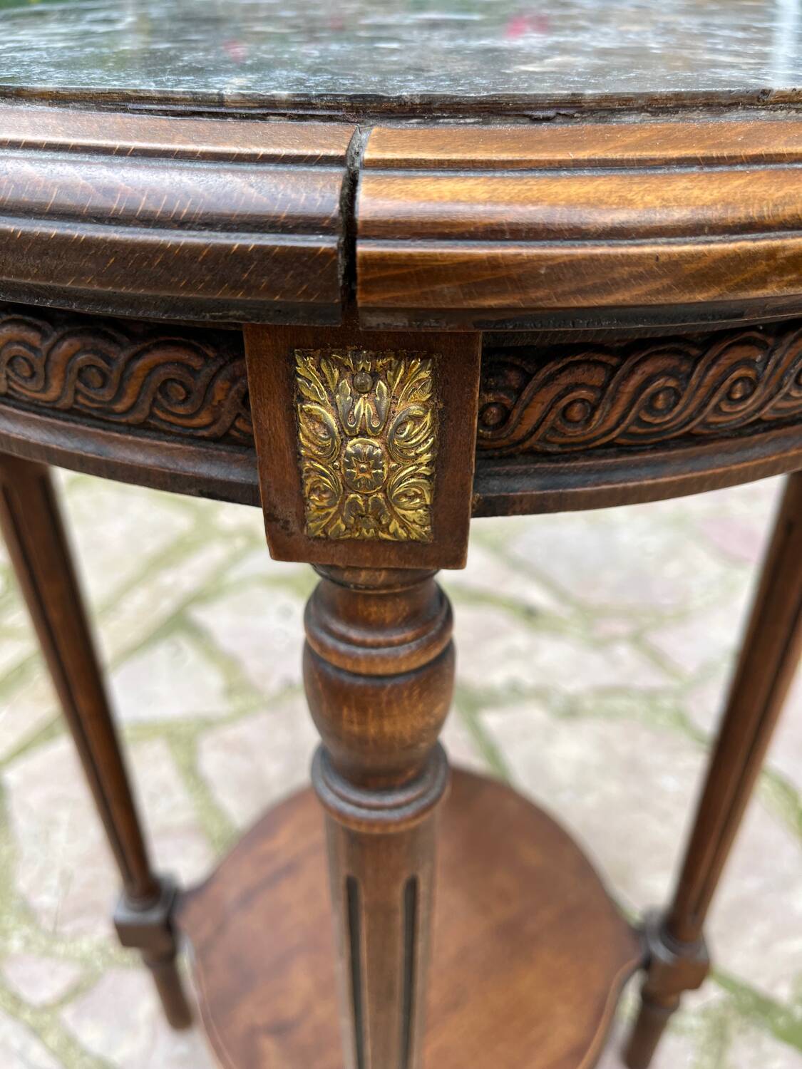Old wooden pedestal table with marble top