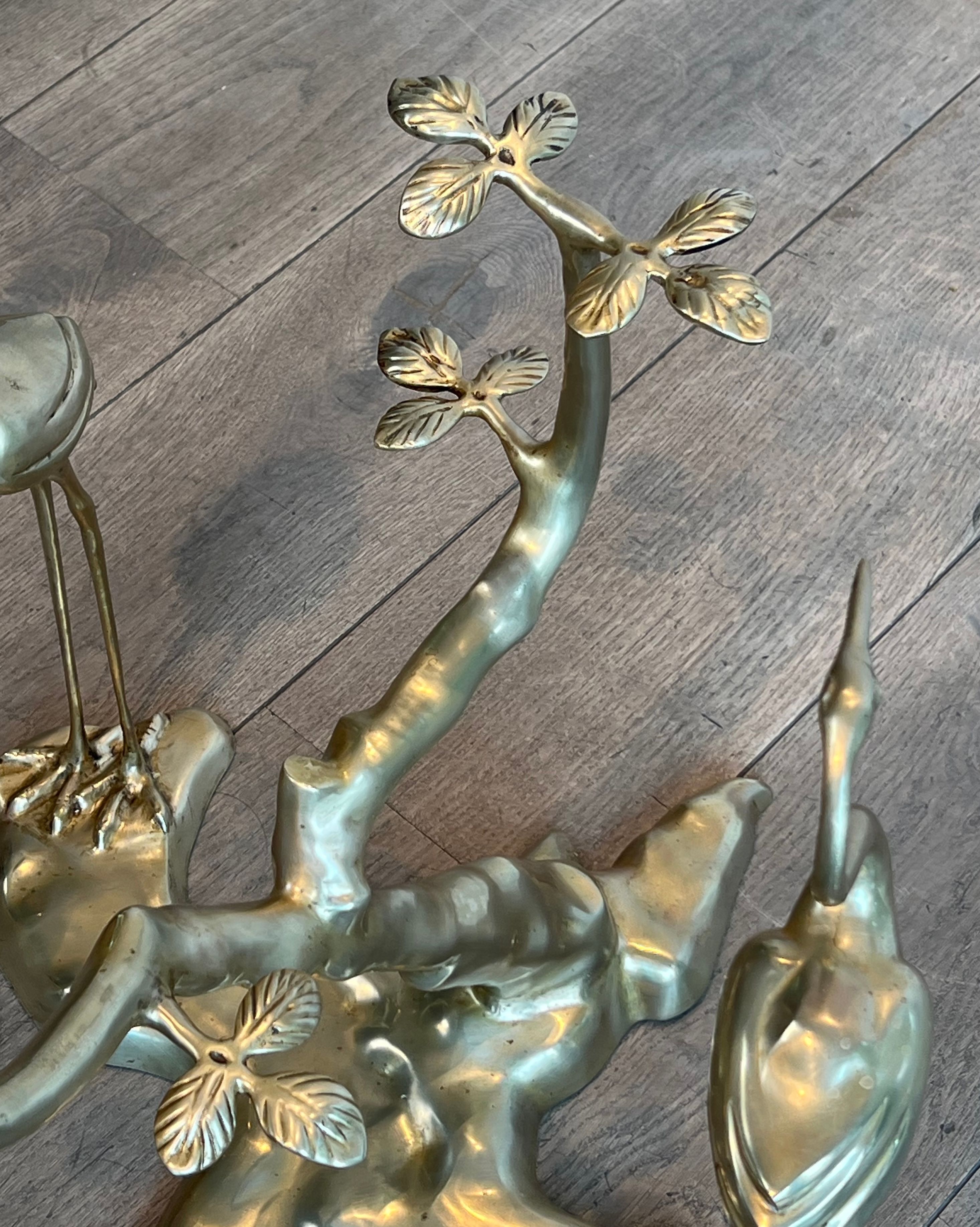 Coffee table model with cranes surrounding a brass bonsai and round glass top by Willy Daro.