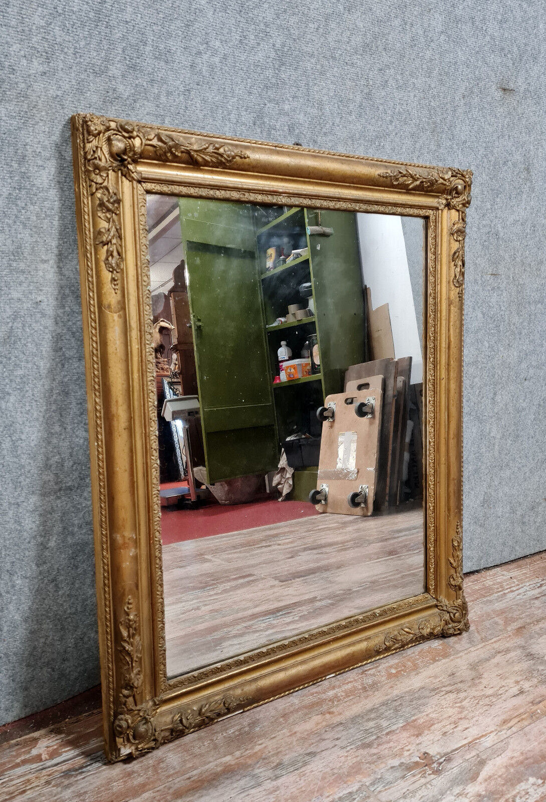 Old nineteenth century mirror in gilded wood and carved around 1850