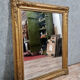 Old nineteenth century mirror in gilded wood and carved around 1850