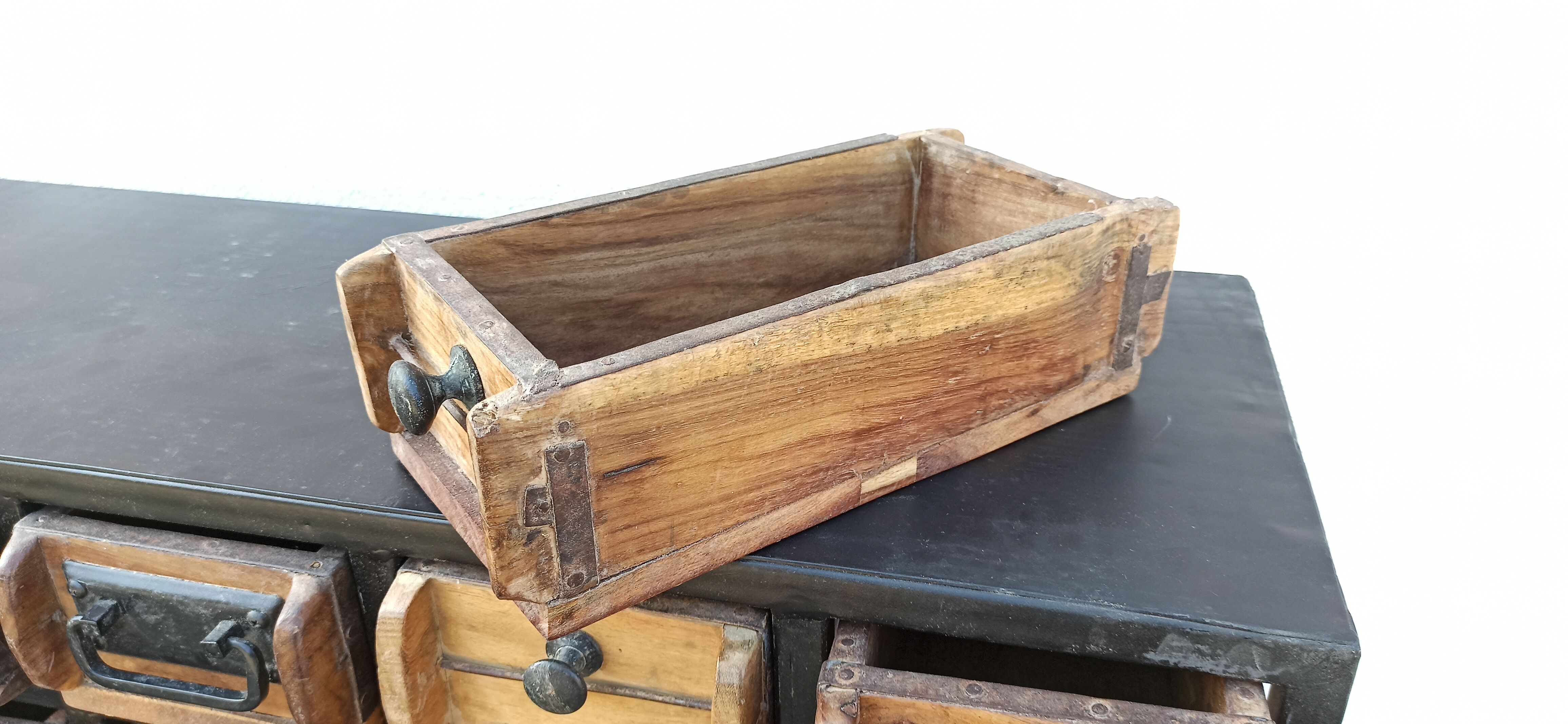 Black metal storage cabinet with 60 wooden drawers