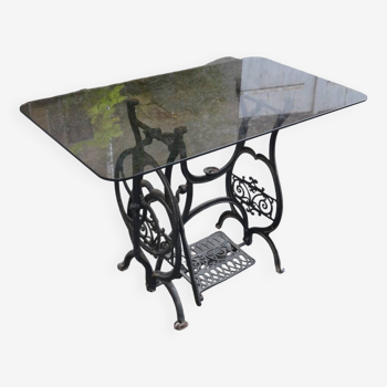 table with old sewing machine base and smoked glass top