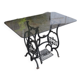 table with old sewing machine base and smoked glass top