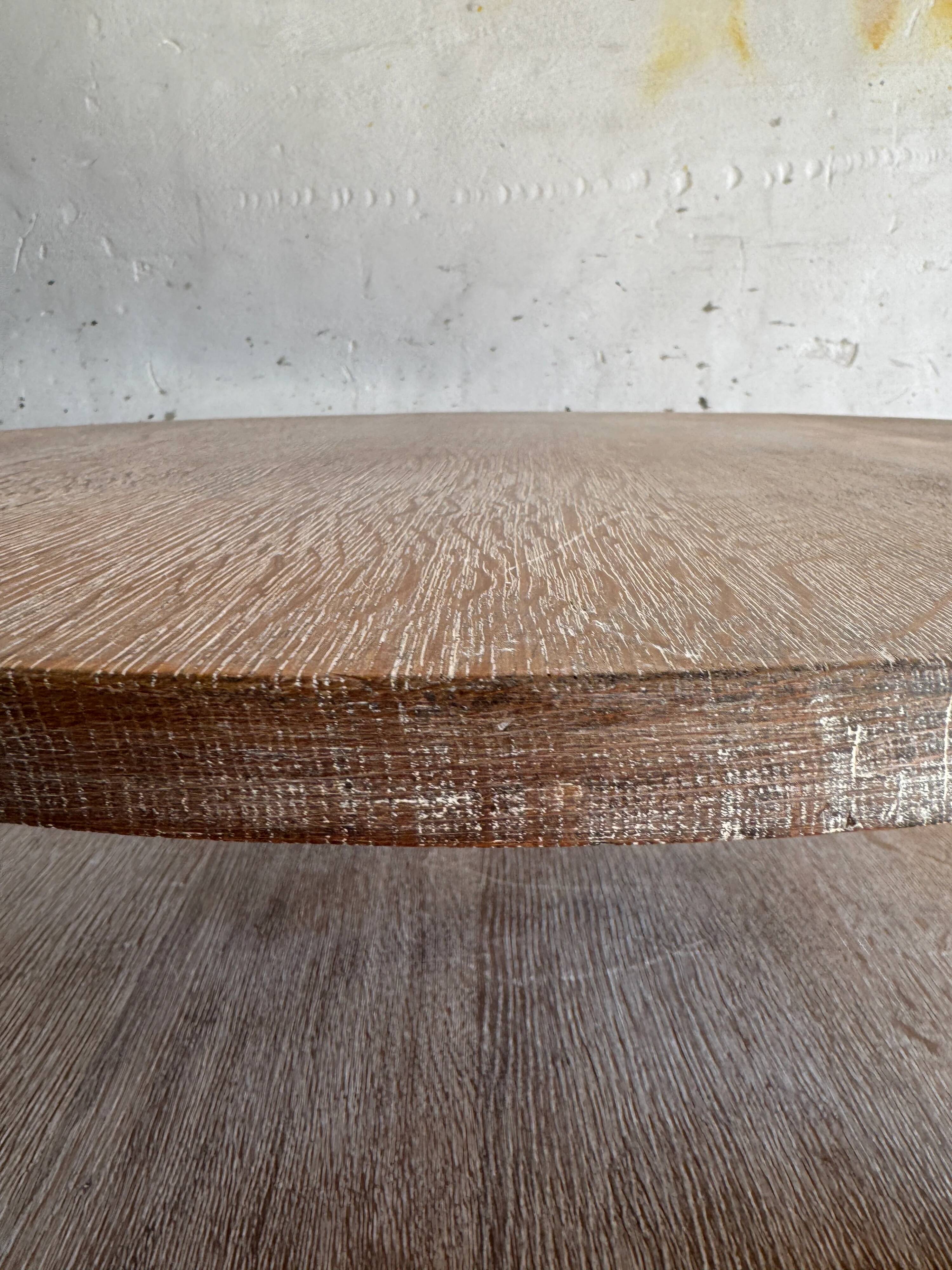 Art Deco round oak side table in light weathered oak with lower shelf, geometric three-leg design