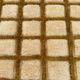 Very large Moroccan Berber rug in ecru and camel 400x300 cm with a grid pattern.