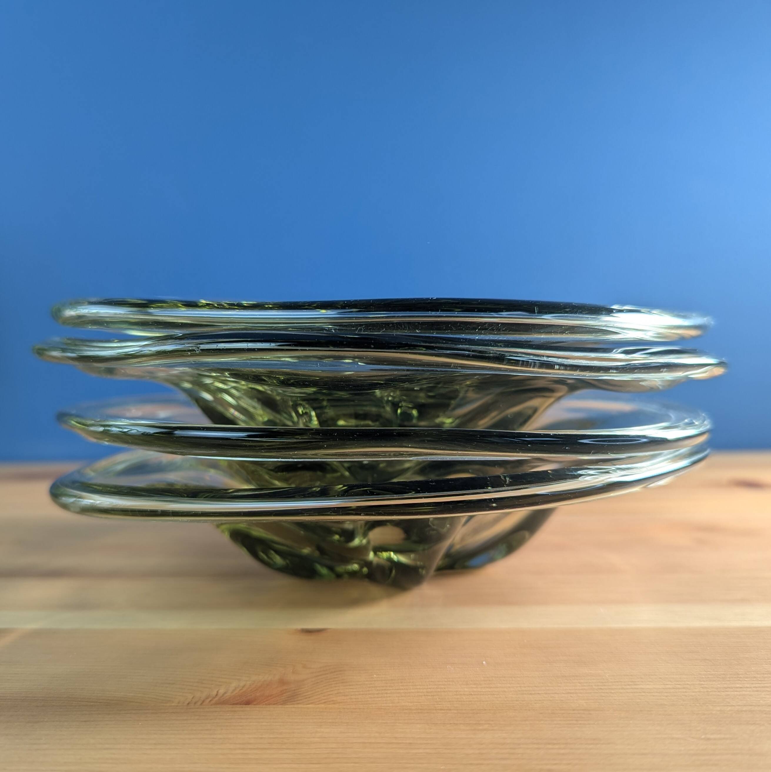 4 wavy glass bowls plates in smoked green design, signed and numbered