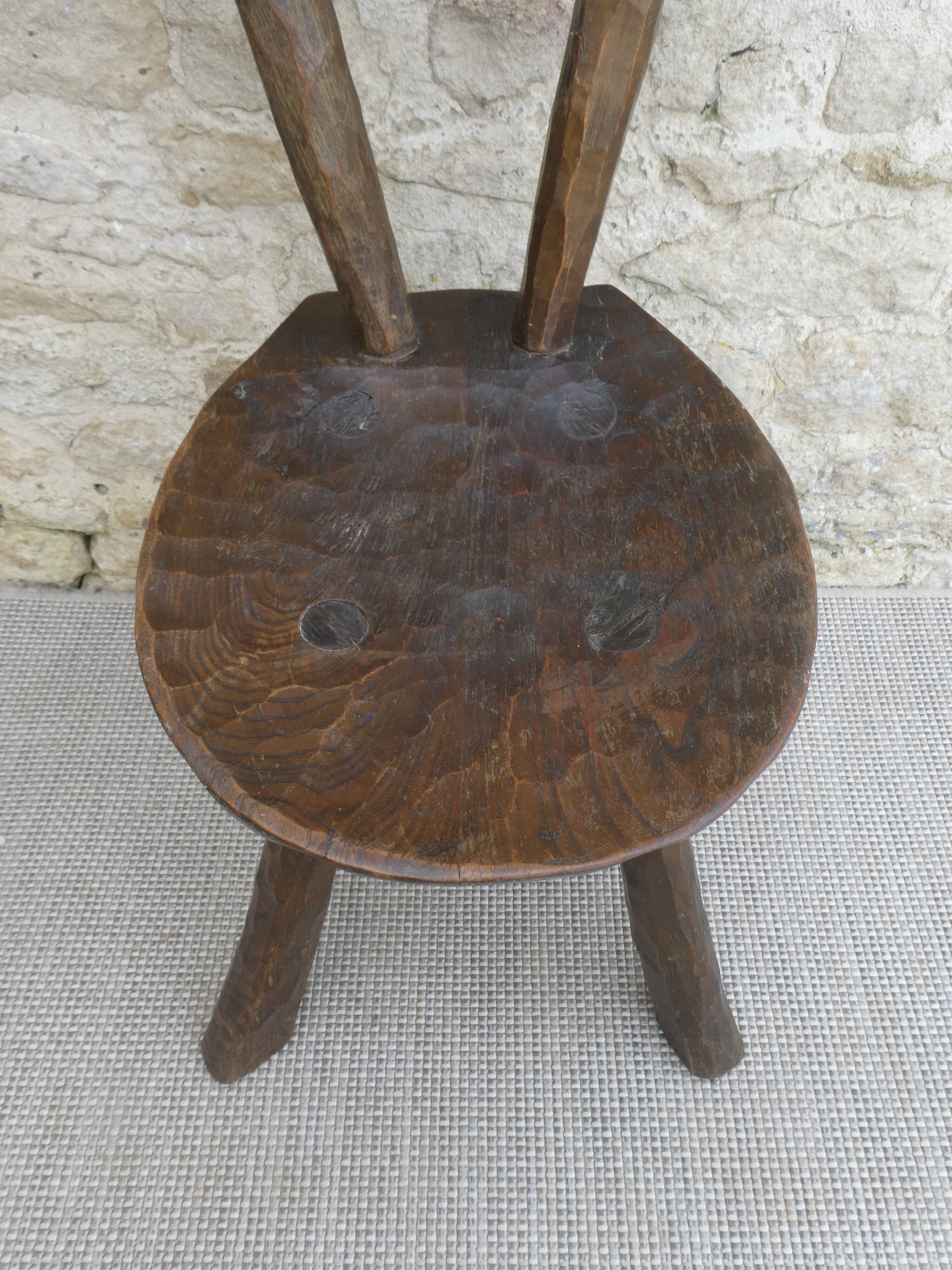Brutalist chair in carved solid wood, around 1950.