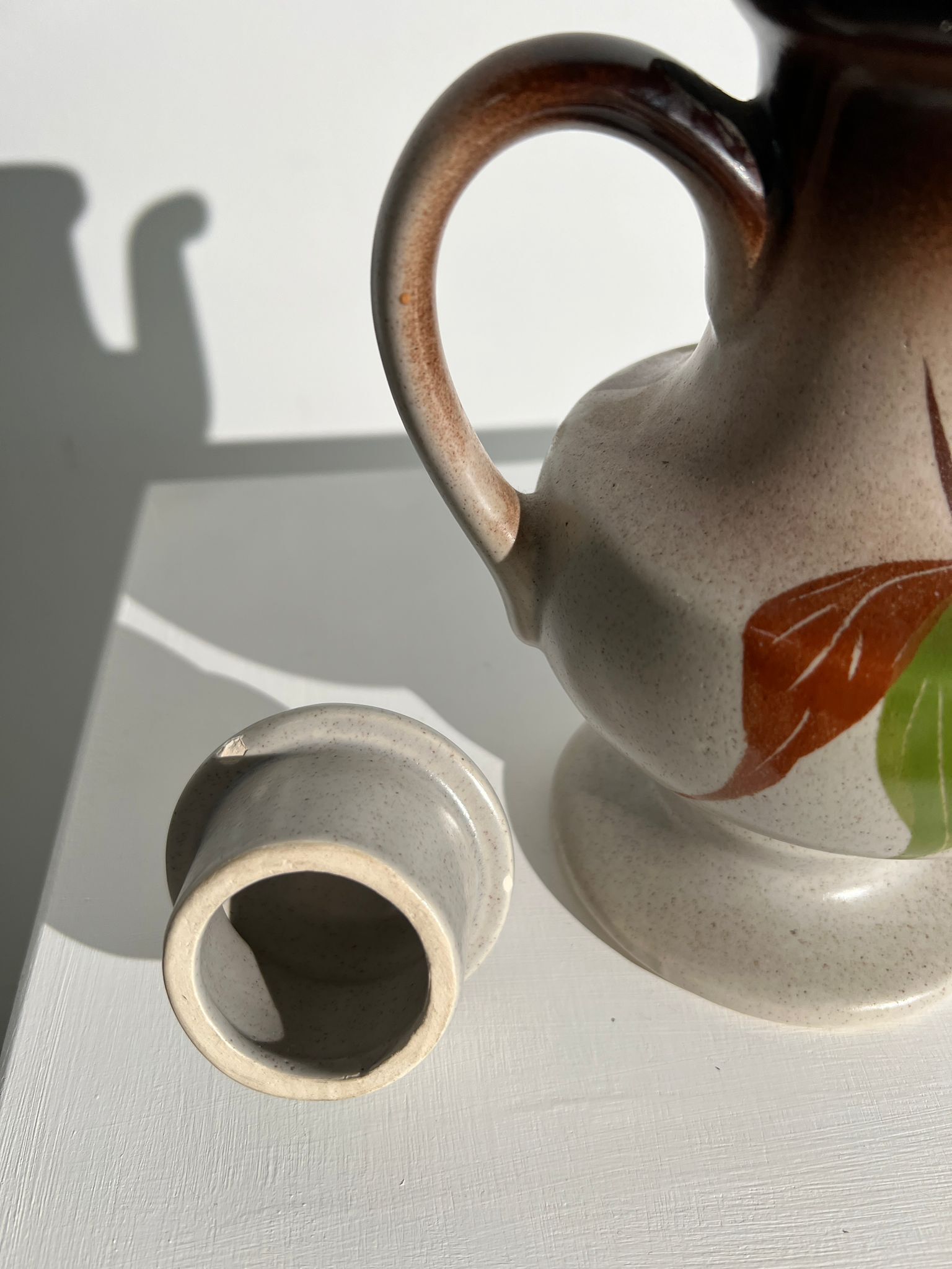 Vintage stoneware teapot with flower and fruit patterns