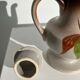 Vintage stoneware teapot with flower and fruit patterns