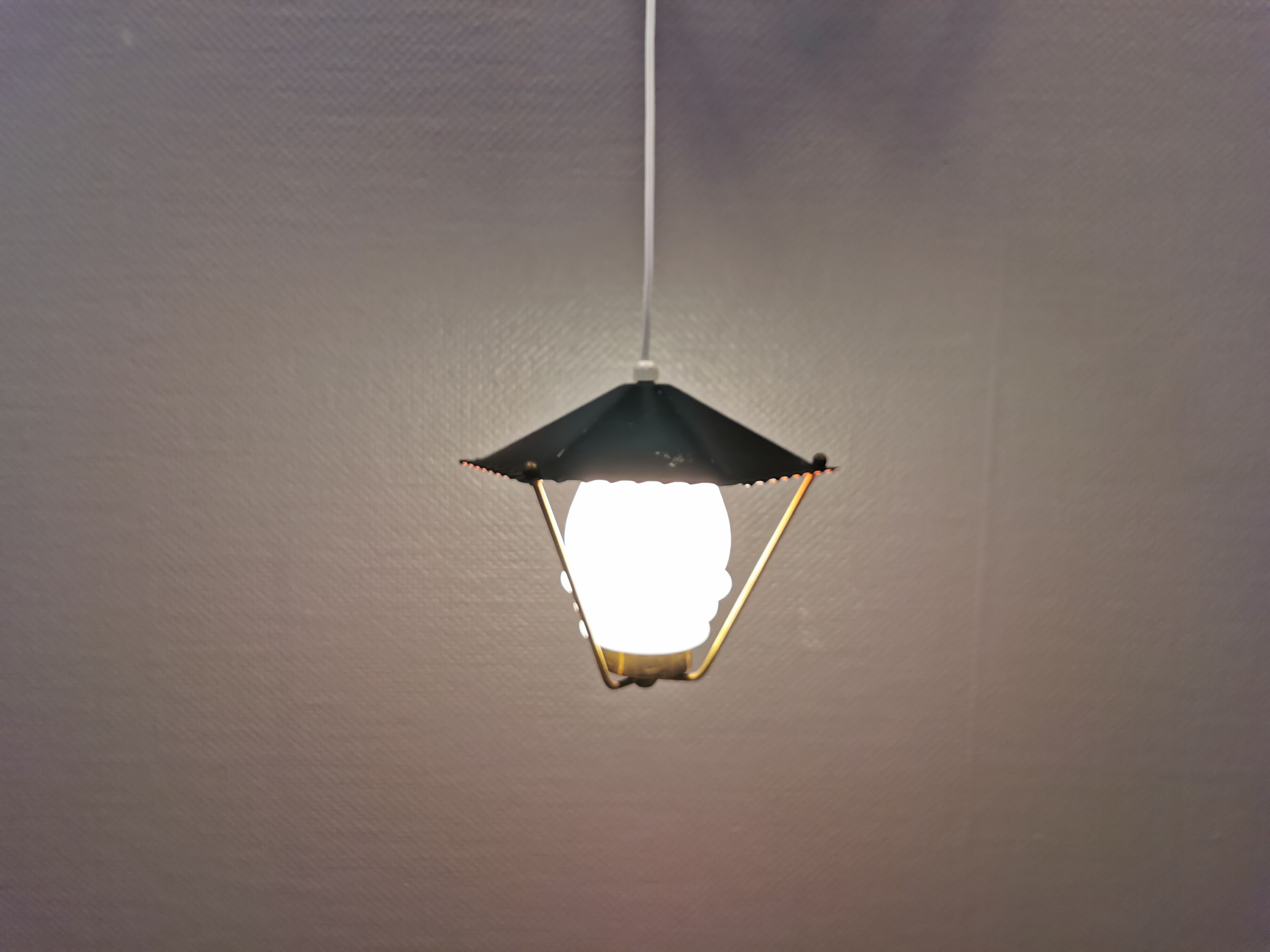 Danish hanging lamp from the 50-60s, made of brass, metal and with milky white glass shade.