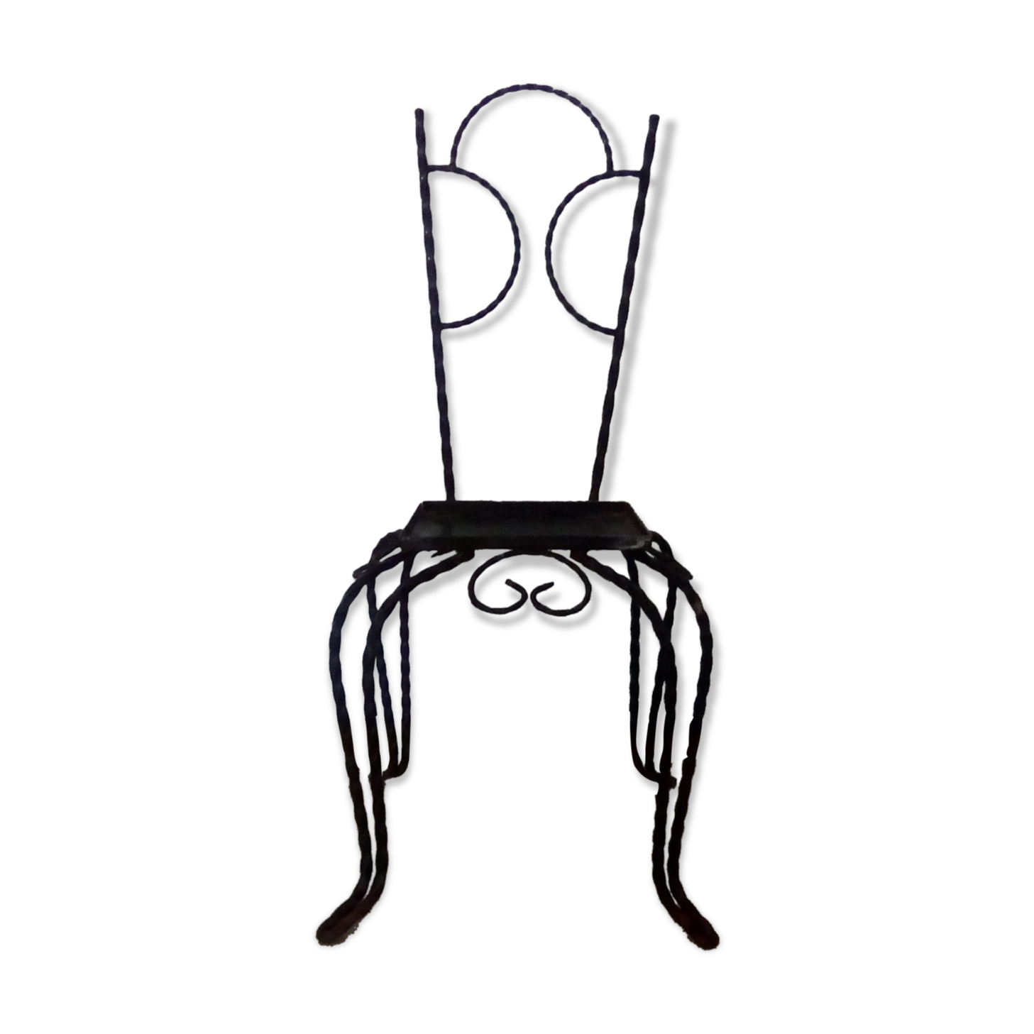 Small chair wears wrought iron plant