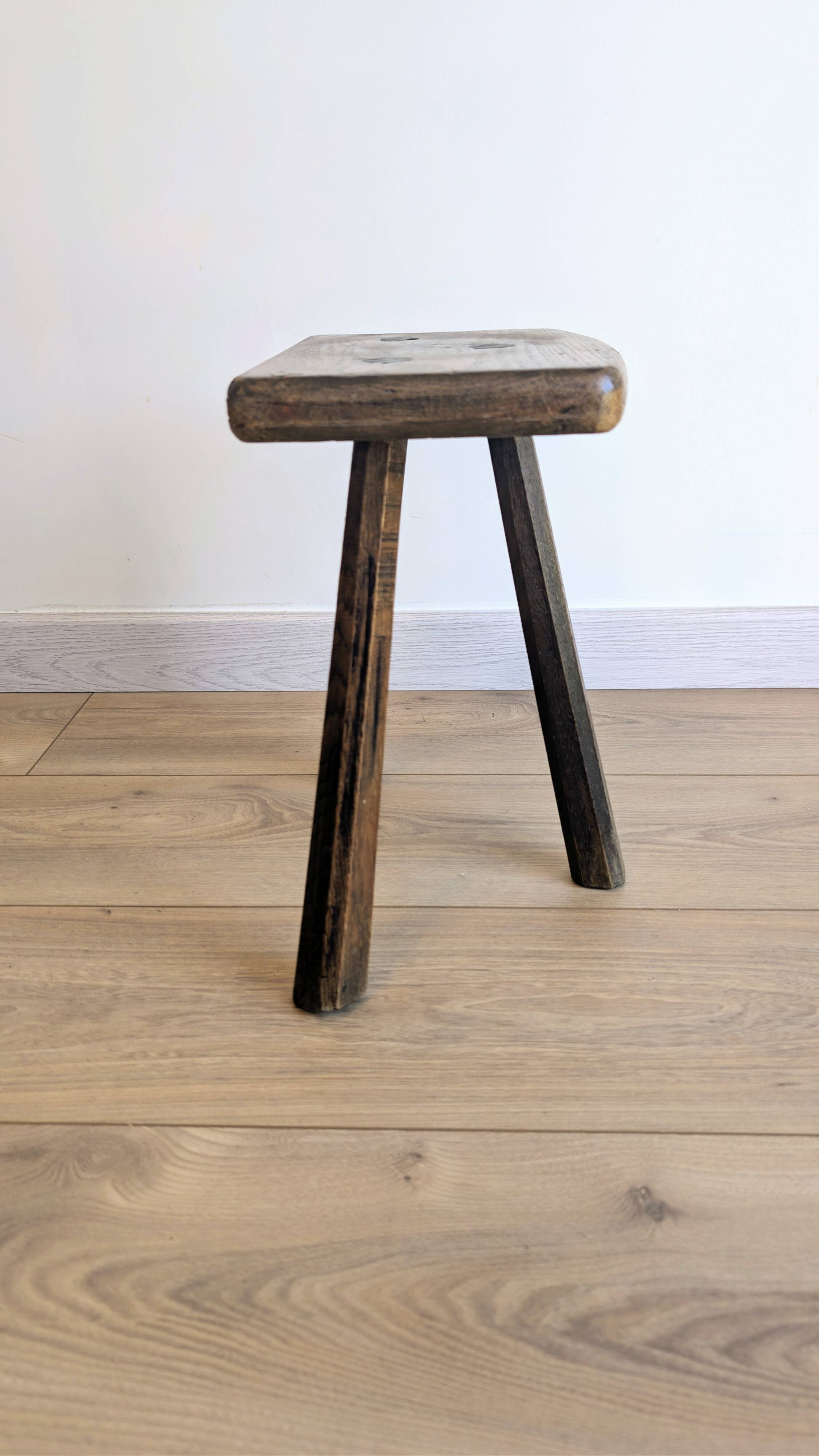 Antique tripod stool in patinated solid wood