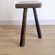 Antique tripod stool in patinated solid wood