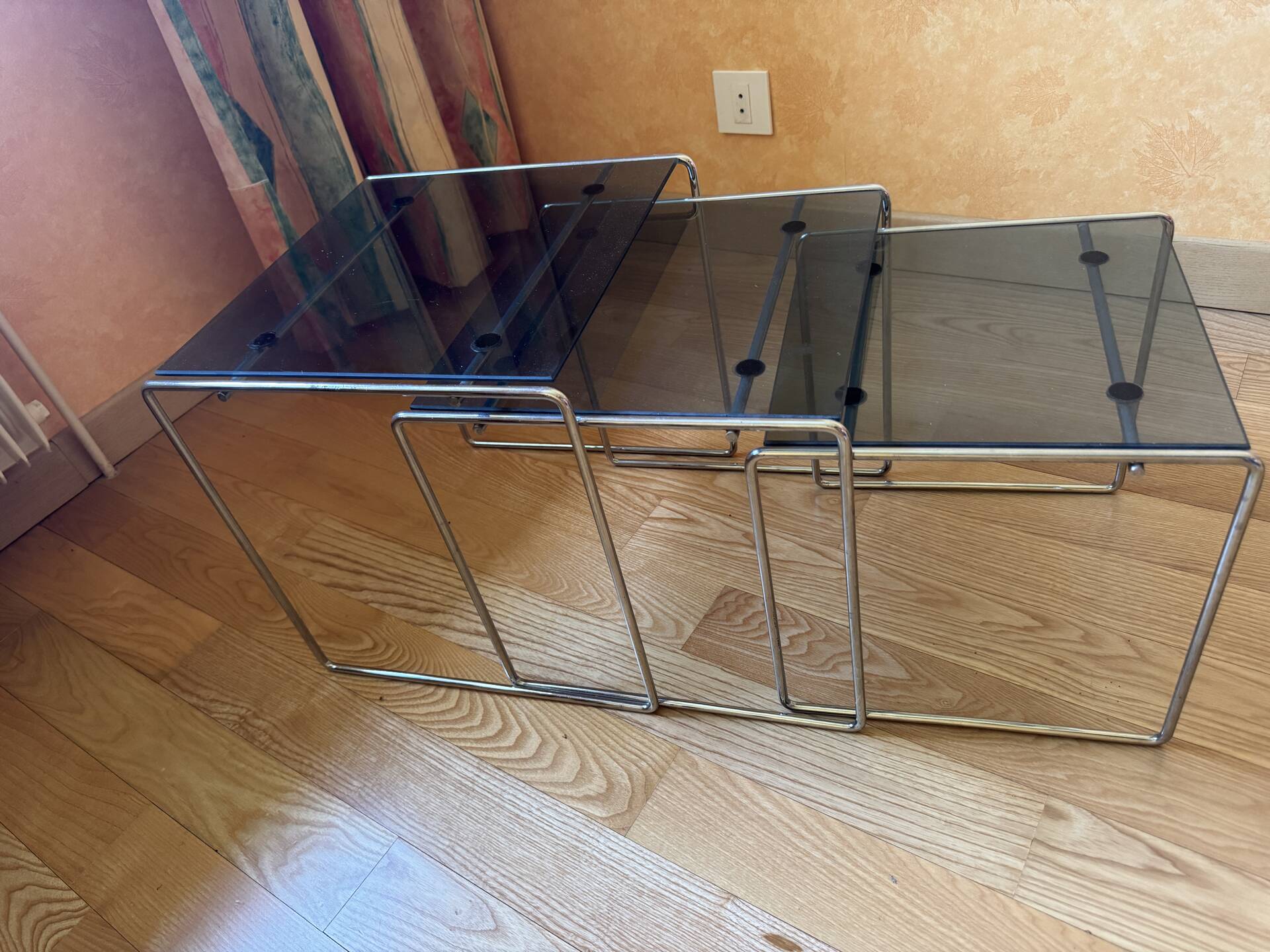 Nest of coffee tables in glass and metal.