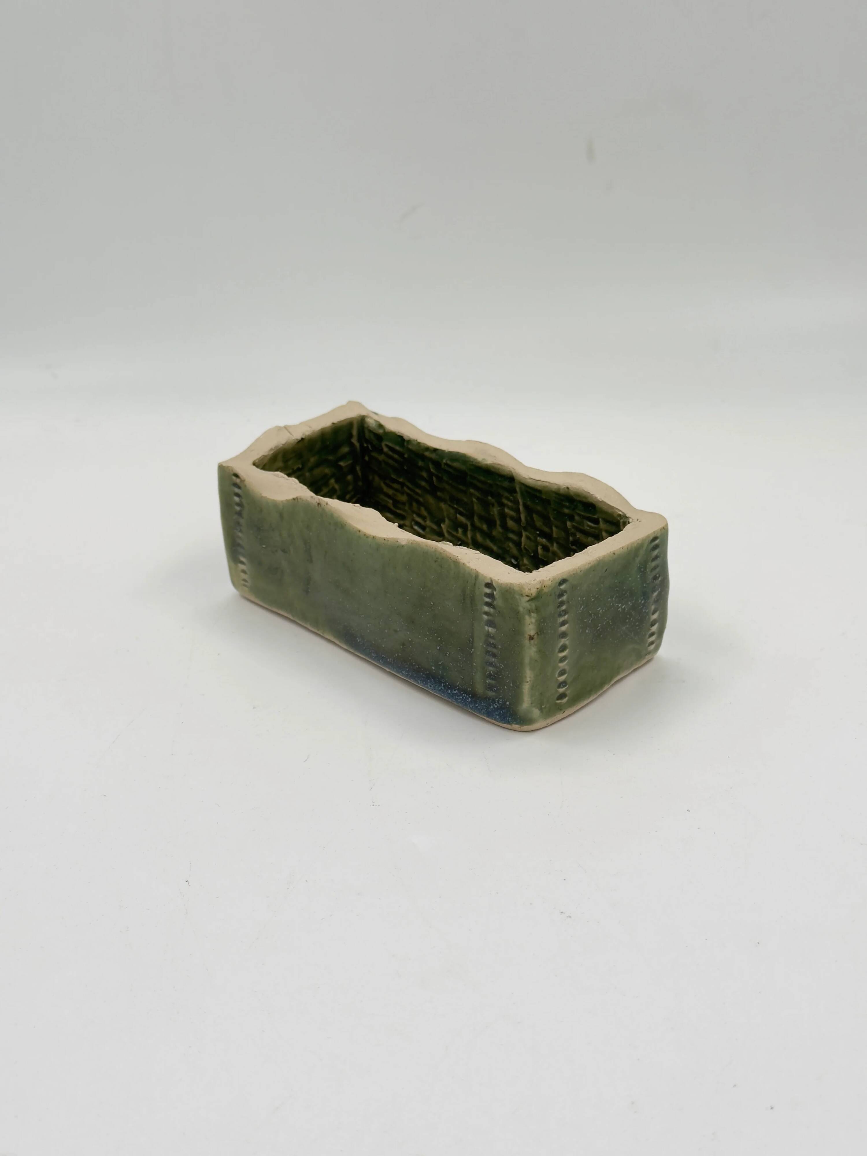 Rectangular ceramic vase signed, woven interior.