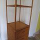 Storage column, wooden bookshelf and woven rattan.