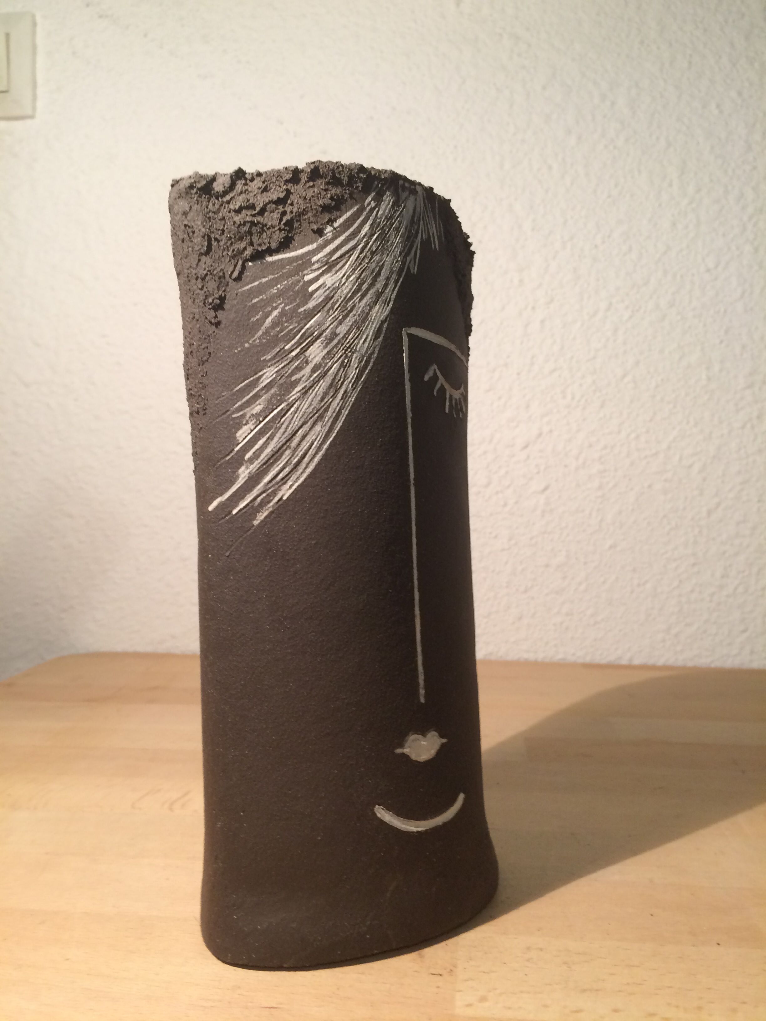 Ceramic vase face, black and white