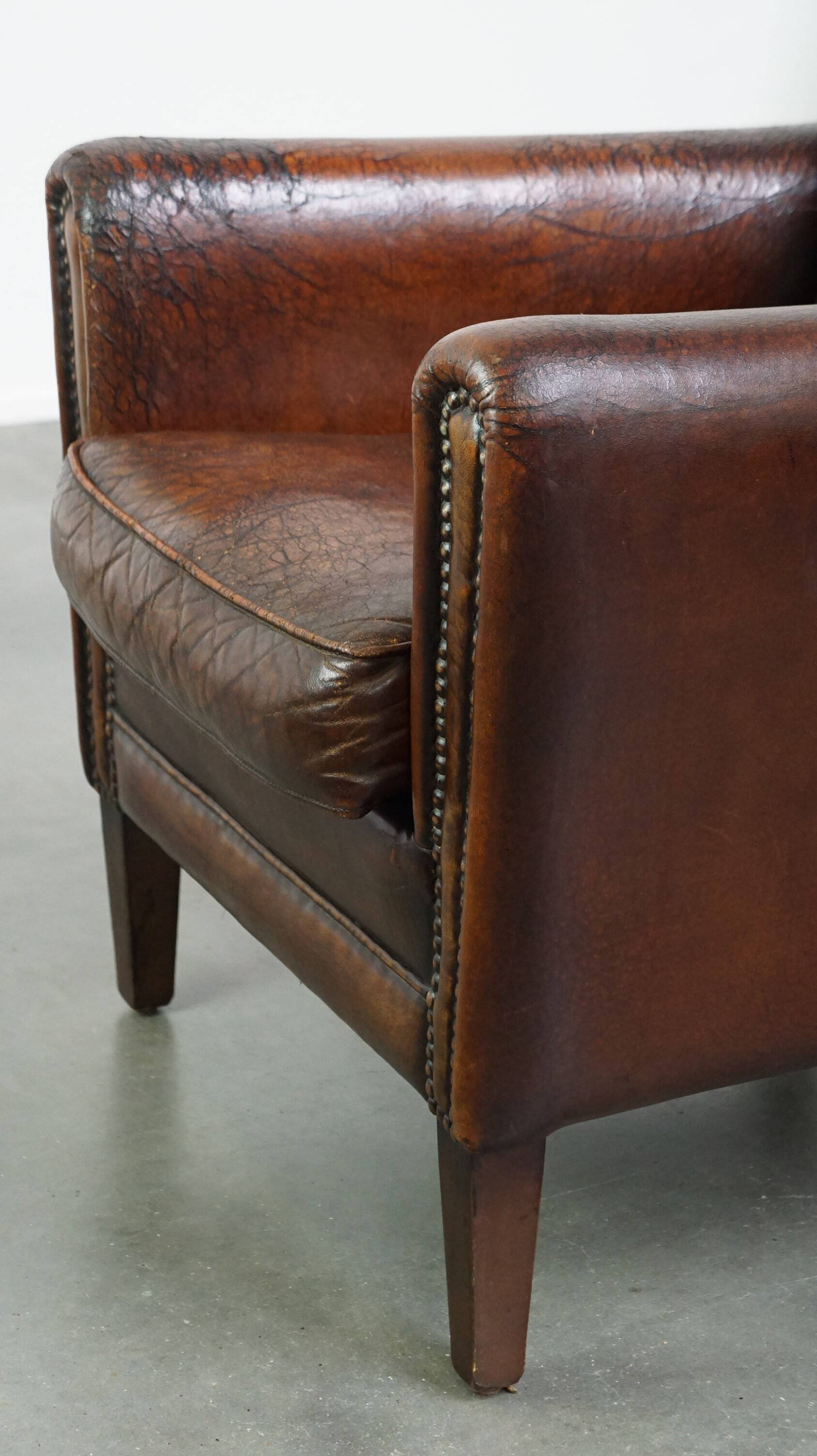 A vintage-style armchair with character, upholstered in beautifully patinated sheepskin.