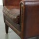 A vintage-style armchair with character, upholstered in beautifully patinated sheepskin.