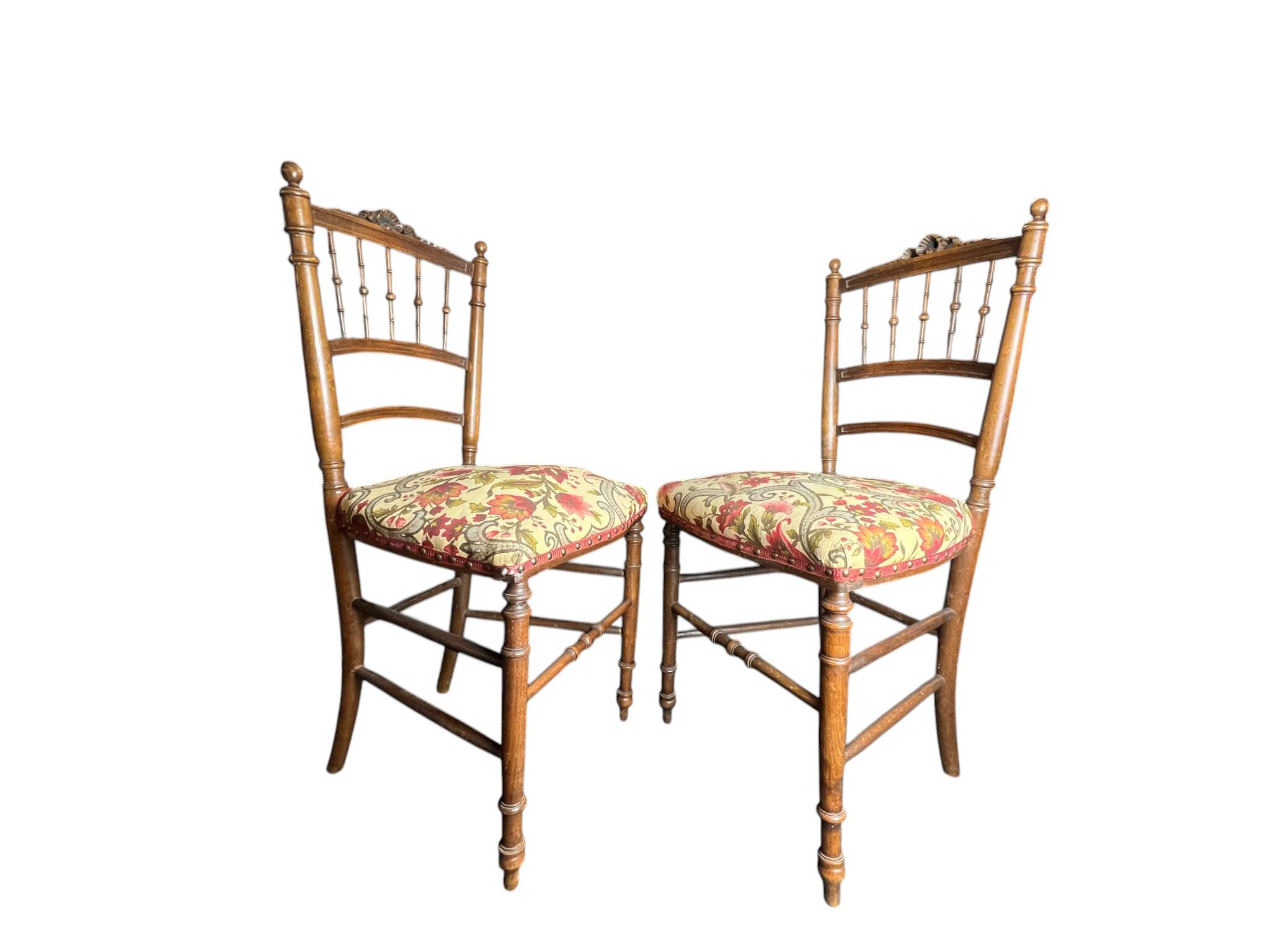 Two floral upholstered music chairs from the early 20th century.