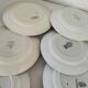 Set of 8 ironstone plates with coordinated designs.