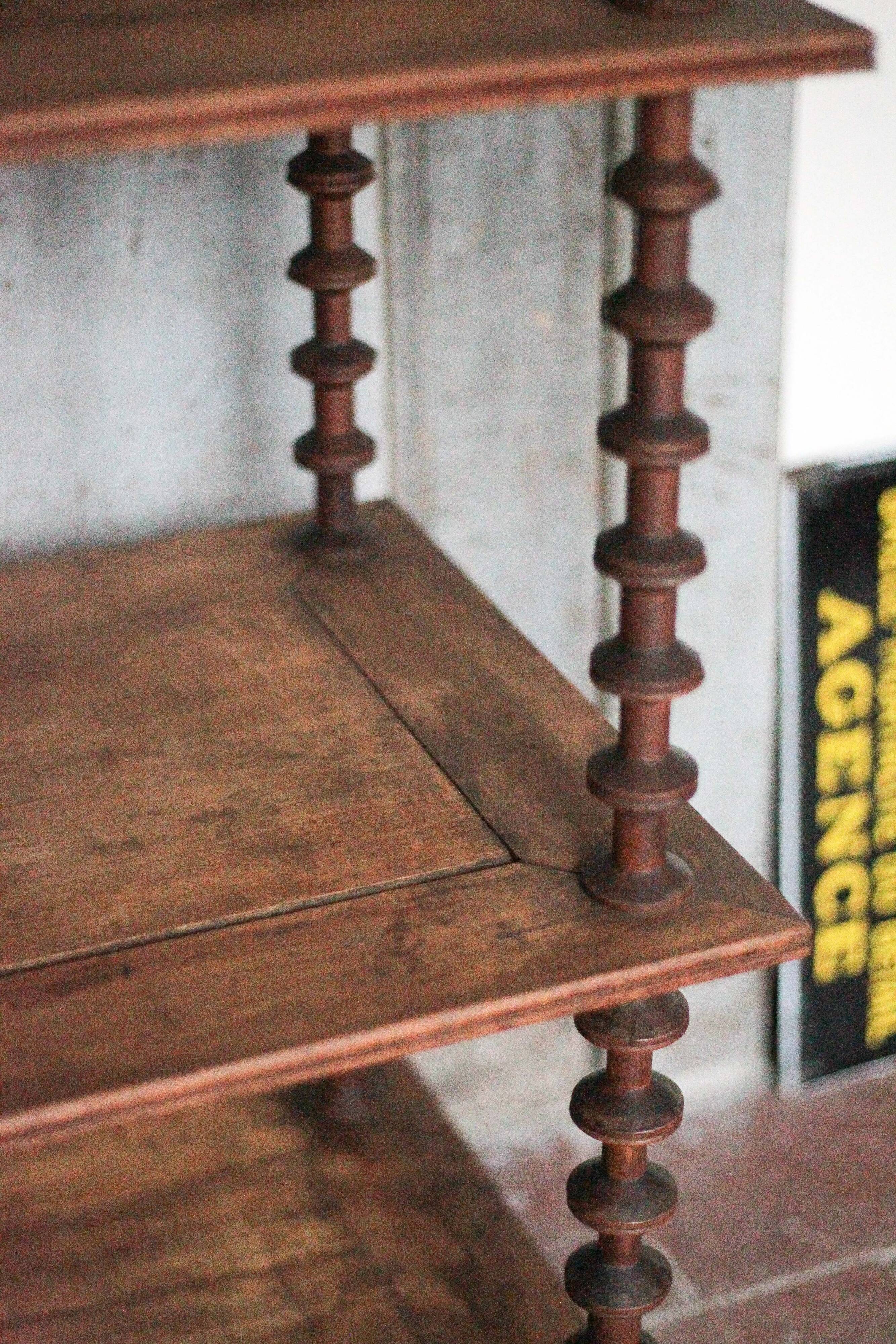 Napoleon III spool shelf, floor-standing shelf with brass tips.