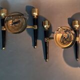 Pair of two-light torchiere wall lights in black lacquered metal and gilded brass, Circa 1960.